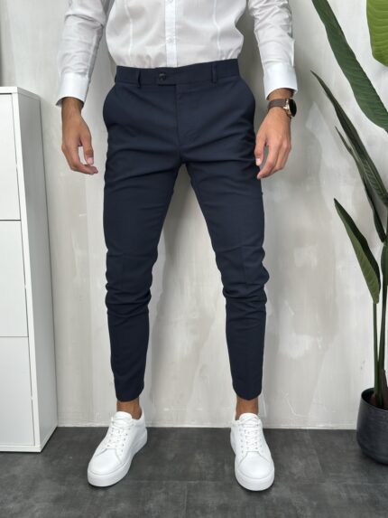 Elegantne muške pantalone sa duplim kopčanjem na prednjoj strani u teget boji, kroj slim fit. Prikaz prednje strane.