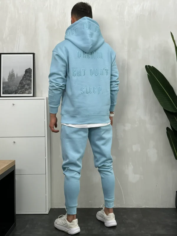 Muška trenerka komplet u svetloplavoj boji sa vezom na ledjima, rukavu i nogavici, zadnji prikaz.