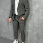 Tamno sivi muški sako sa jednostrukim kopčanjem, prikaz celog outfita u kombinaciji sa belom košuljom i patikama.